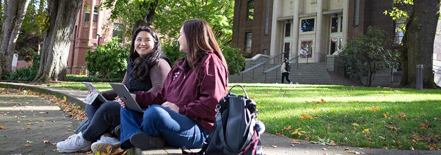 SPU students work on their laptops in Tiffany Loop on campus